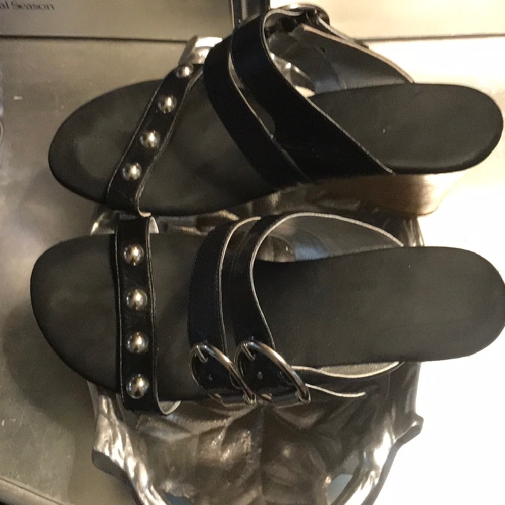 Black with studs and buckles!  Nice wedge by Onyx